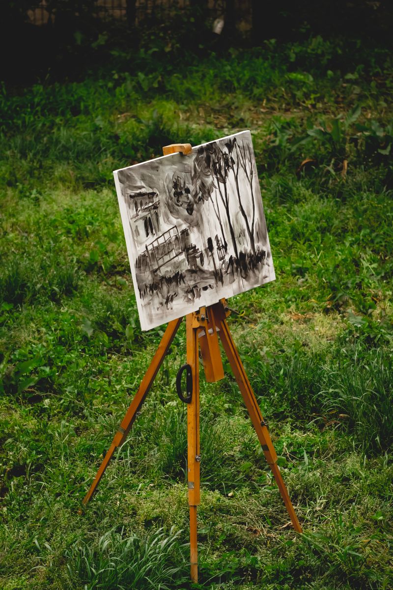 A watercolor painting drying on an easel in a bright studio